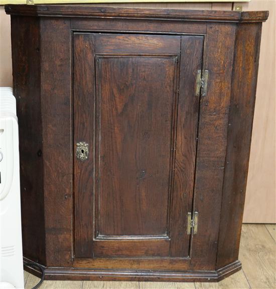 A George III oak corner cupboard, W.83cm